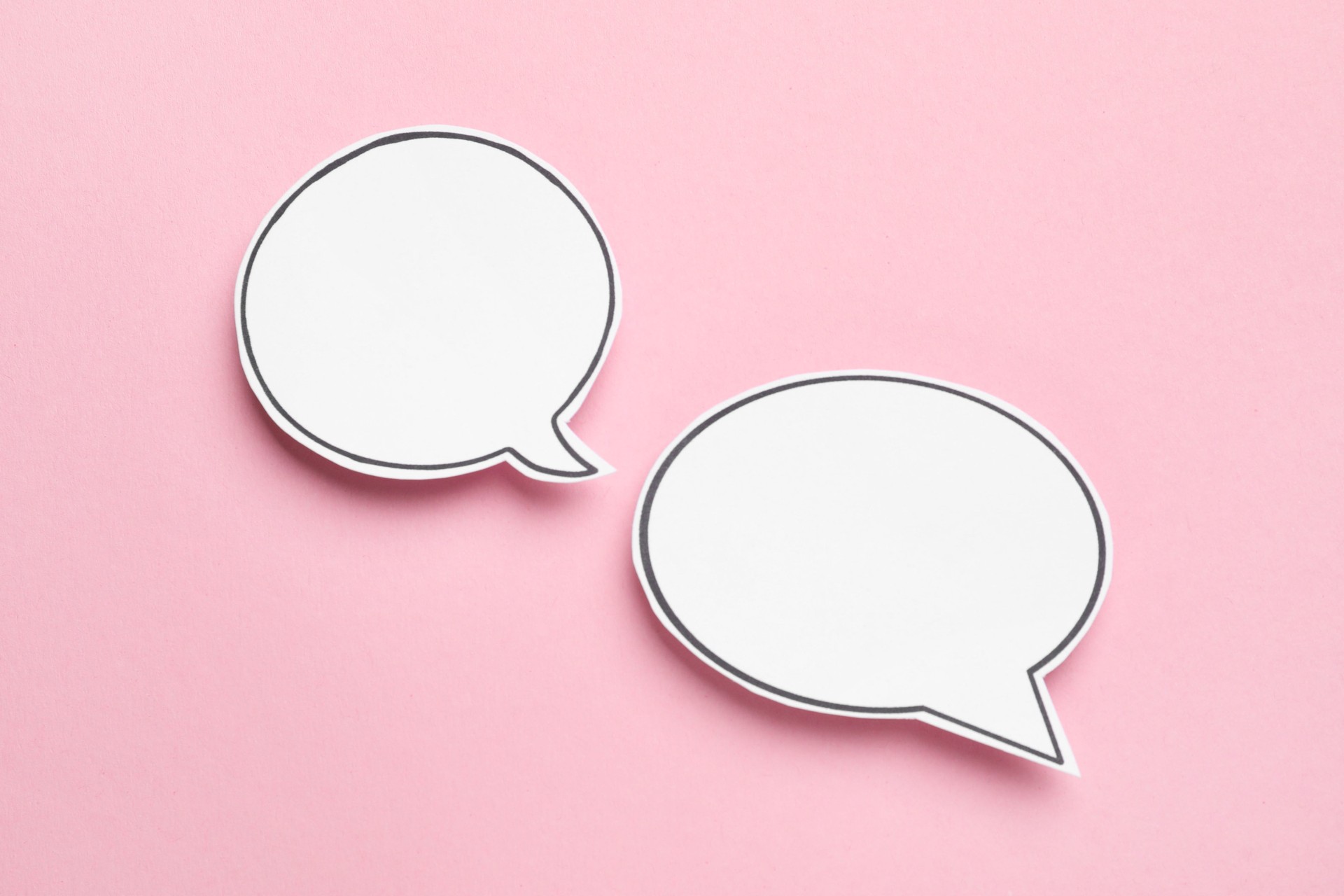 Blank speech bubbles on light pink background. Space for text